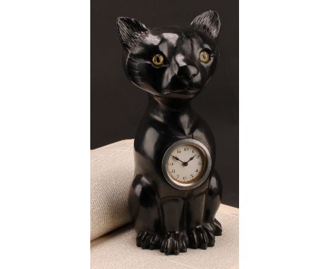An early 20th century ebonised novelty timepiece, carved in the Black Forest manner as a seated cat of Louis Wain inspiration