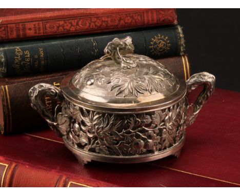 A Chinese silver coloured metal dish and cover, pierced and chased with flowers and scrolling leaves, 126cm over prunus root 