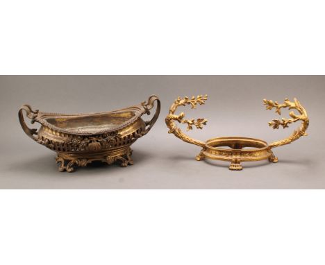 A French Louis XV style gilt brass boat shaped table centre, in the Rococo taste, pierced and applied with floral bouquets an