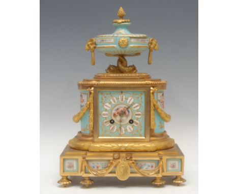 A late 19th century French gilt brass and ormolu mounted porcelain mantel clock, urnular crest with pineapple finial, pair of