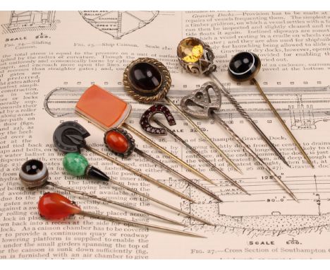 Stick Pins - a late 19th century base metal polished agate bull's eye pin, 7cm; others, polished pear shape carnelian, carved