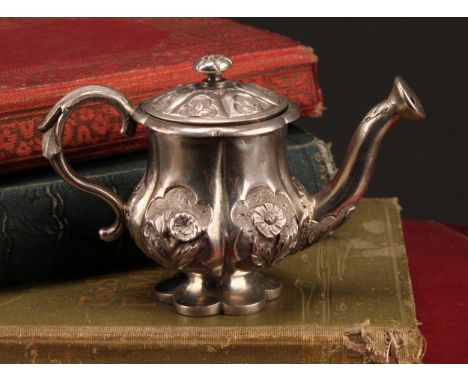 A Chinese silver coloured metal novelty pepper, as a watering can, chased with flowers, 9.5cm long, apparently unmarked, c.19