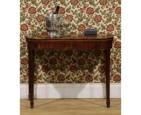 A George III mahogany card table, hinged top enclosing a baize lined playing surface, tapered square, spade feet, outlined th