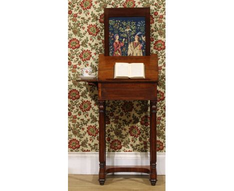 A George/William IV mahogany fireside work or reading table, hinged top angle-adjustable on a ratchet, before a pull-up fire 