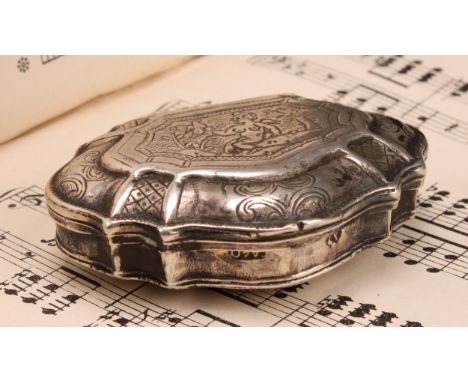 An 18th century Continental silver shell shaped snuff box, hinged cover engraved with a scantily clad putto, within Rococo bo