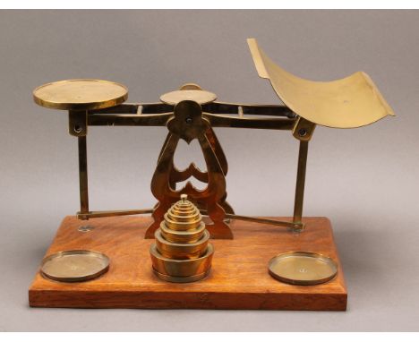 A set of Edwardian brass parcel post balance scales, the circular tray inscribed with insurance rates, part set of brass weig
