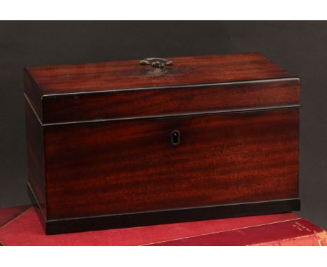 A George IV/William IV mahogany rectangular tea caddy, the hinged cover centred by a swing handle, enclosing three removable 