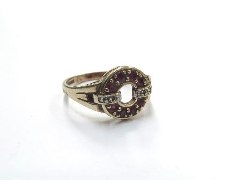 A 9ct gold ruby and diamond ring of circular form. Size O, 2.7g