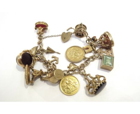 A 9ct gold charm bracelet hung with an 1892 gold sovereign, 1905 gold half sovereign, 9ct gold carousel, five gold seals incl