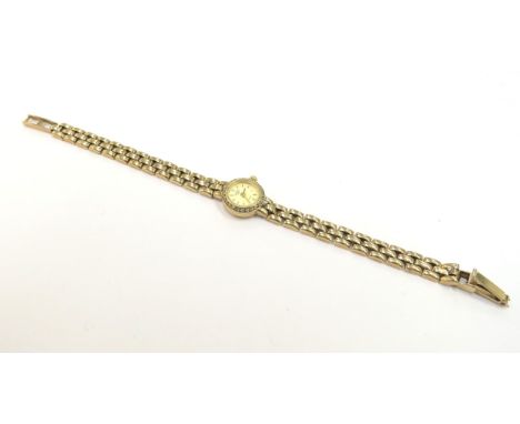 A Rotary 9ct gold lady's wristwatch with 9ct gold strap and diamond set bezel, 12mm diameter dial, 12.1g