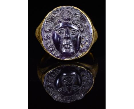 CA. 200 AD. Very Rare Ancient Roman gold ring; oval hollow hoop forming large bezel; beautifully carved amethyst cameo insert