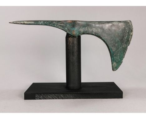 Ca. 1250 - 650 BC. A cast axe head comprising a tubular socket flared adze to one side and axe blade to the other; supplied o