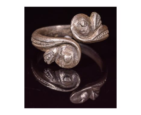 Ca.100 AD. A nice Roman silver ring formed by a round silver hoop; with dolphin head terminals; Good wearable condition; D:18