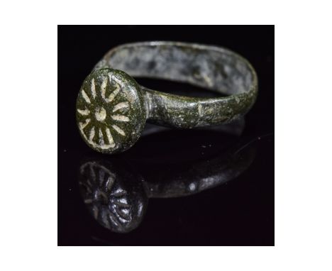 Ca.1000 AD. An Interesting Medieval ring with a round hoop; circular bezel depicting Sun Motif; Fine Condition; wearable; D:2