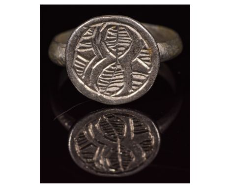 CA. 800 AD Interesting Medieval period silver ring; a round hoop with applied oval bezel; depicting a stylized path going thr