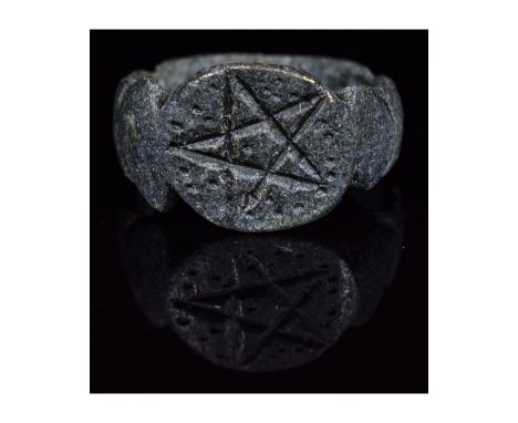 Ca. 200 AD. Interesting Ancient Roman ring with oval hoop; forming round bezel with an engraved pentagram. Very good, wearabl