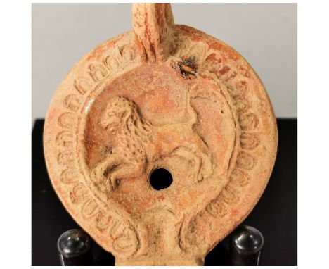 Ca.200-300AD. A nice terracotta oil lamp; the discuss decorated with lion motif; Good condition; on stand; L:85mm;3.35in; 35g