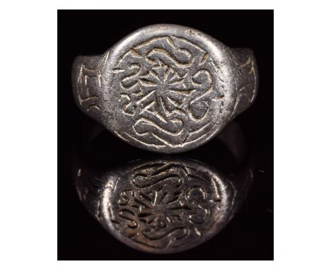 CA. 900 - 1100 AD. Interesting Viking period silver ring; composed of a silver hoop with round oval-shaped bezel; engraved wi