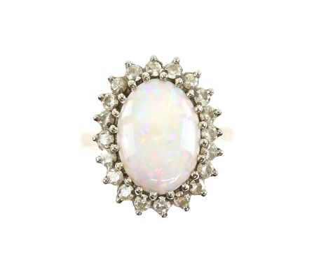 Opal and diamond ring, oval cabochon cut opal measuring 14.0 x 10.1 x 3.1mm, weighing an estimated 2.54 carats, surrounded by