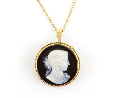 Carved cameo brooch pendant, with a rope detail border and a brooch pin and fold down bail, stamped 18 ct, on a belcher link 