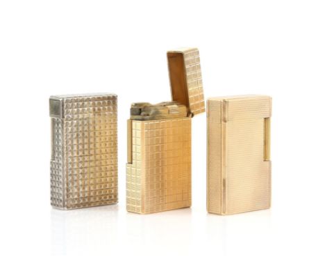Three S T Dupont lighters, two in gilt metal, one with diamond decoration no. Q4PU46 and one with squared decoration no. Y3LR