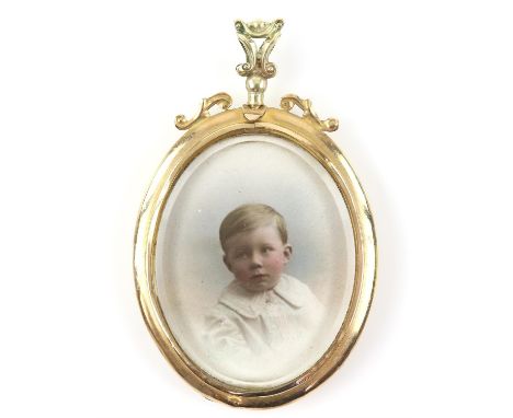 Antique open locket pendant, central oval glazed panel with coloured photographs of a baby boy and gentleman, stamped 9 ct, 6