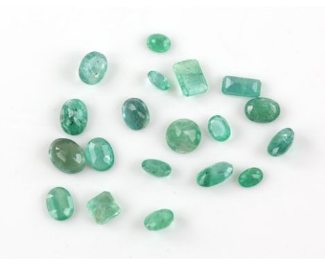 Nineteen loose faceted emeralds, including fifteen oval cuts weighing between 1.84-0.34 carats, a round cut weighing an estim