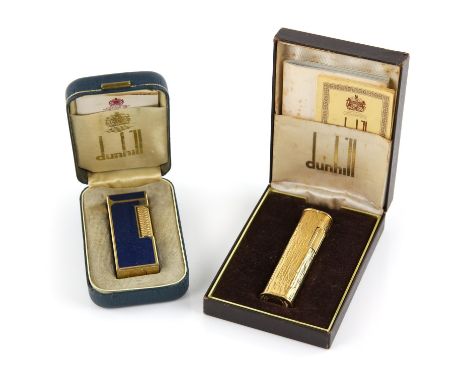 Two Dunhill lighters, one blue enamel rectangular shaped one that's gold plated, in original box with booklet, one gold plate