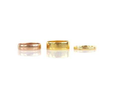 Three gold rings, including a 6.2mm wedding ring, in 22 ct, ring size M, a 2.2mm wedding band, in 18 ct, ring size J and a 4.