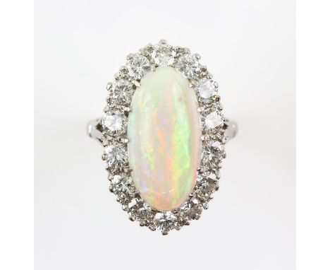 Opal and diamond cluster ring, central oval cabochon cut opal, estimated weight 2.35 carats, set within a border of round bri