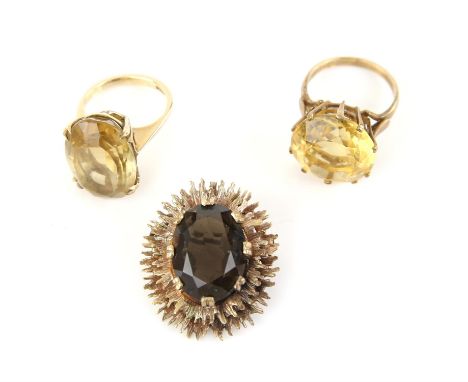 Two citrine cocktail rings, one set with a round cut citrine, weighing an estimated 18.50 carats, ring size R, and an oval cu