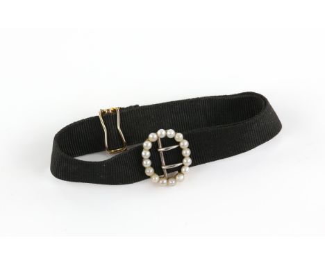 Victorian pearl and material bracelet, black woven strap with a seed pearl buckle and 15 ct clasp, length 12-21cmCondition Re