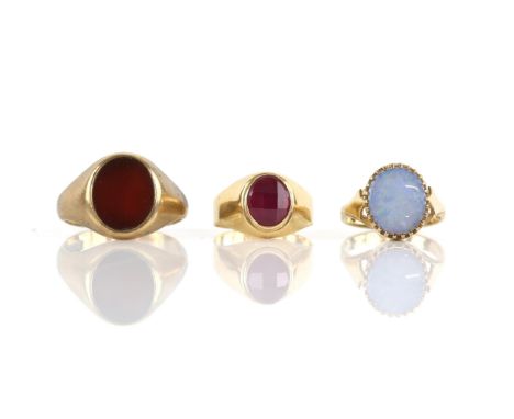 Three rings, a checkerboard cut synthetic ruby ring, testing as 18 ct, an oval carnelian signet ring, size V, opal doublet ri