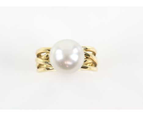 Abstract pearl cross over ring, pearl measuring 11.5mm in diameter, mount stamped 18 ct, ring size M 1/2Condition Report:  18