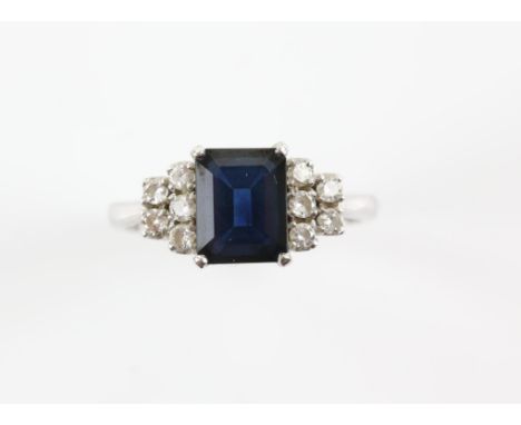 Sapphire and diamond ring, central emerald-cut sapphire weighing an estimated 2.70 carat, set with five round brilliant cut d