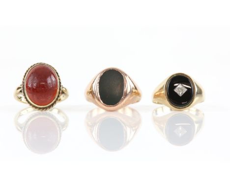 Three gem set rings, including a bloodstone signet ring, ring size R1/2, an onyx and diamond signet ring, ring size R and a c