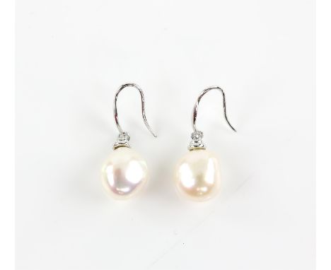A pair of pearl earrings, baroque cream pearls measuring an estimated 11.67 x 10.06mm, suspended from hook fittings, by Micha