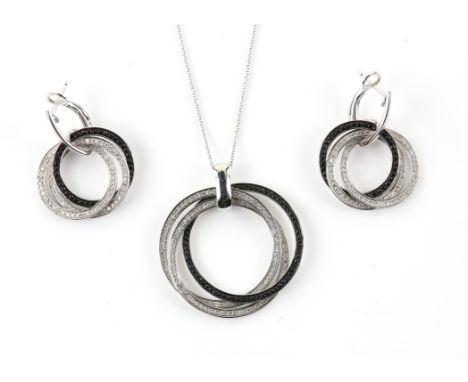 Contemporary black and white diamond pendant with matching earrings, designed as three interlocking circles, two set with sin