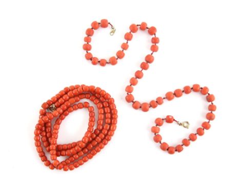 Two coral necklaces, one long bead necklace strung on a chain, with a gilt metal clasp, 81 cm in length and another with larg