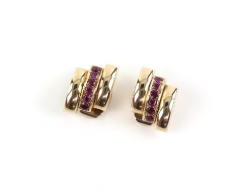 1950's ruby clip on earrings, designed as three tiered gold panels, the central panel set with six round cut rubies, with a c
