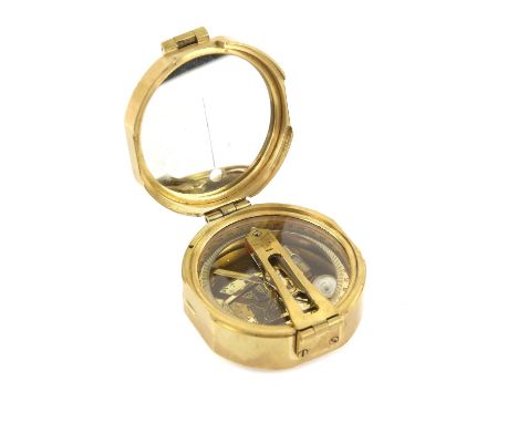 Brass handheld Geological Surveying Brunton Compassthe hinged mirror lid revealing compass and adjustments for altitude, plum