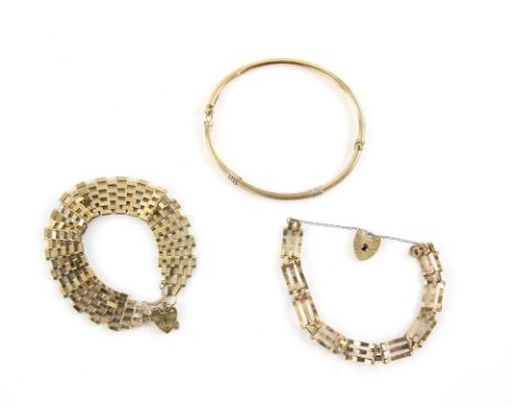 Three bracelets, including a hinged bangle, and two vintage gate bracelets, all in 9 ctCondition Report:  Gross weight approx