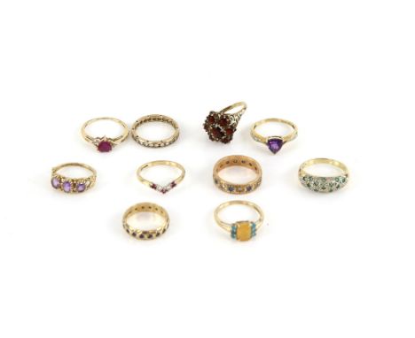 Ten gem set rings, including a garnet cluster ring, size N, a heart shaped ruby ring, size N, a ruby and cubic zirconia wishb