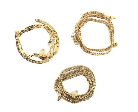 Three gold chains, including two curb link chains in 9 ct, one measuring 52cm and 47cm and a fancy link chain stamped 14 ct, 