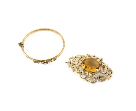 Edwardian seed pearl bangle, with clover leaf and flower detail, mounted in 9 ct and a large Victorian brooch, set with an ov
