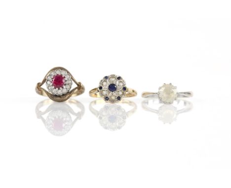 Three gem set rings, including a single stone white sapphire ring, stamped platinum, ring size P1/2, a sapphire and paste clu