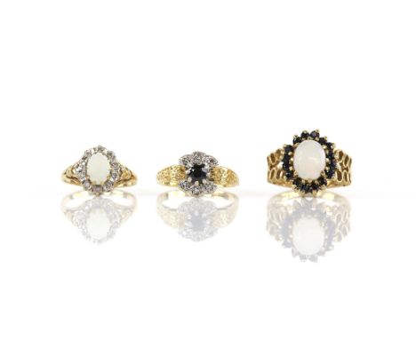 Three gem set rings, including an opal and sapphire cluster ring, size K, and an opal and diamond cluster ring, size I1/2, bo