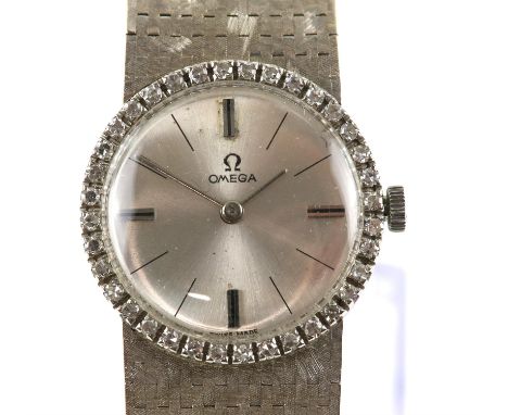 Omega, a Ladies white gold dress watch, diamond set bezel, estimated total diamond weight 0.50 carats, surrounding a silvered