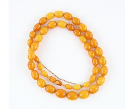 Amber bead necklace, graduated oval beads, largest bead measuring 17 x 13mm, smallest bead measuring 10 x 7mm, strung without