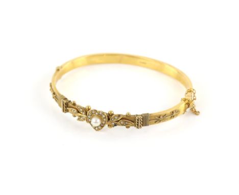 Edwardian pearl hinged bangle, set with a 4mm pearl set to the centre of a seed pearl heart and floral motif, with wirework d